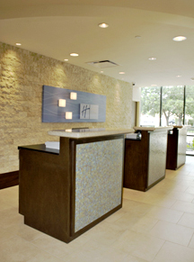Hotel Registration Counters constructed in wood, granite and mosaic tile present a stylish, professional yet comfortable greeting for hotel guests.