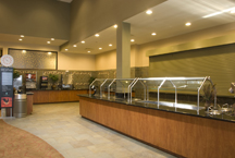 Granite countertops and wood counters for hotel cafeteria's food serving areas.