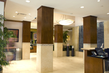 Hotel lobby features a combination of stone, tile, and wood paneled columns that add a professional yet distinctive charm to the character of this urban center hotel.