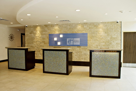 Hotel Reception Desk contruction using wood capentry, millwork, and finishing, and granite countertops, custom tile facing, and decorative accent lighting installtion to form an open, personalize reception for guests.