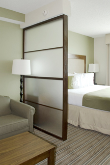 Custom wood and glass room dividers by Bonier enable owners to provide guests personal space within guest room.