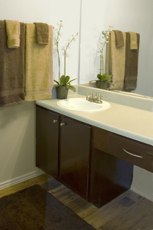 Bathroom vanity and sink countertop resurfacing and cabinet and drawer refinishing for multi-unit apartment complex.