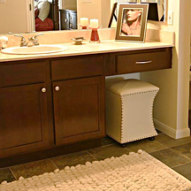 Bathroom vanity features new granite countertops and true to theme refinished windowpane style cabinetry