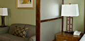 Custom wood and frosted glass sectional screens for hotel guest rooms.