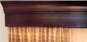 Distinctive upscale wood valences for hotel guest rooms.